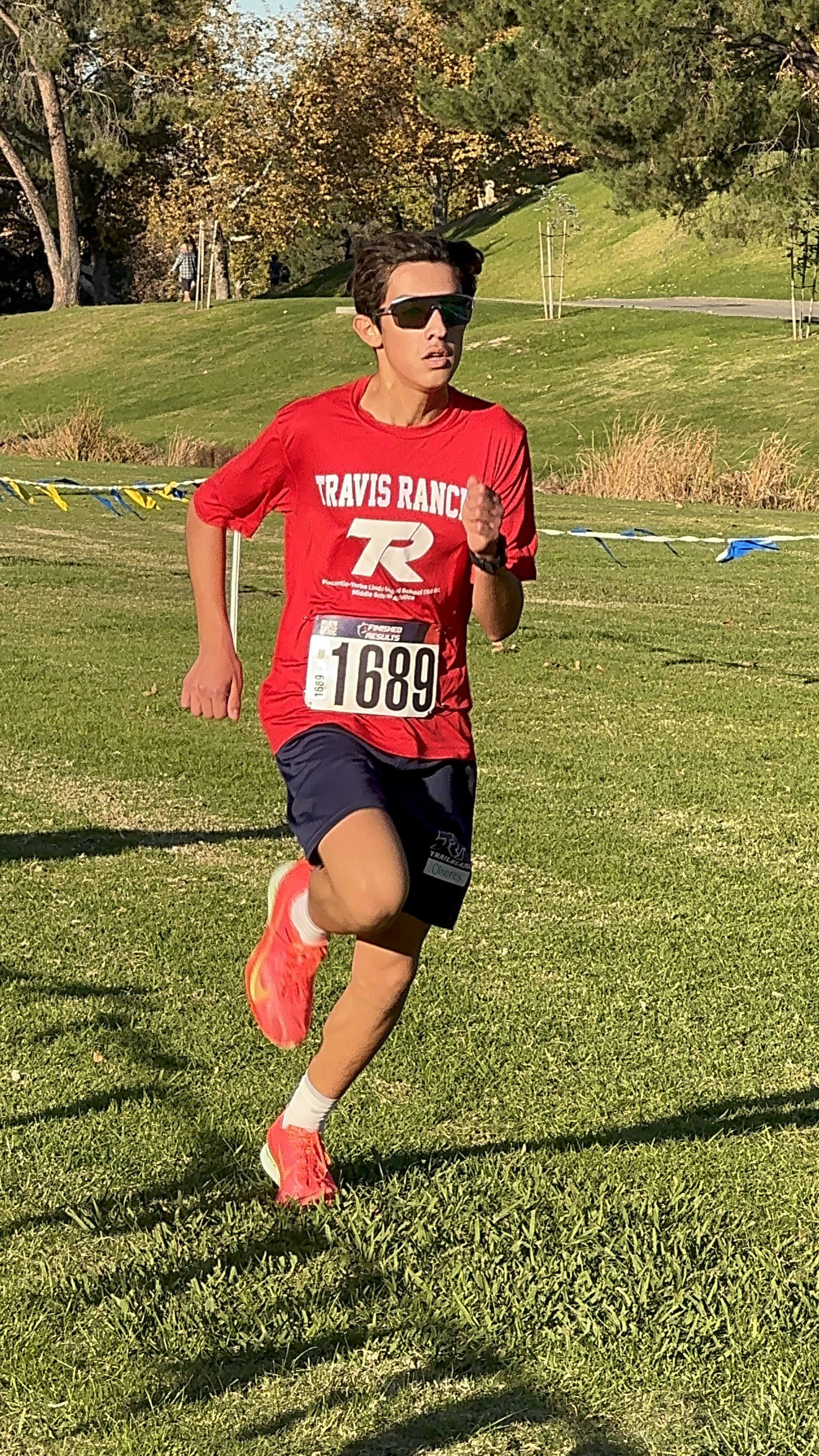 Noah Olivares racing at a cross country meet, bib number 1689